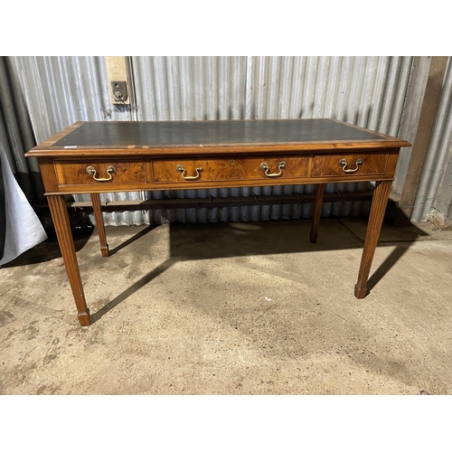 210 - A reproduction yew wood three drawer writing table with brown leather top 140 x 70x 74