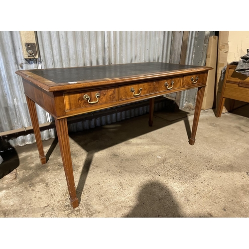 210 - A reproduction yew wood three drawer writing table with brown leather top 140 x 70x 74