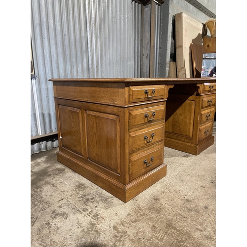 212 - A oak twin pedestal office desk with two drawers and two cupboard doors and a brown three section le... 