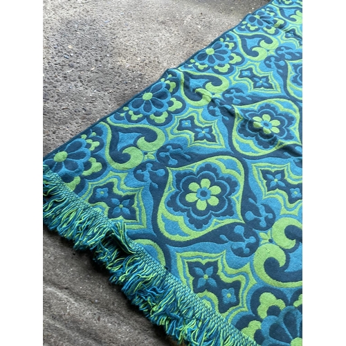 228 - A retro blue and green pattern rug sixe 6' x 8 '