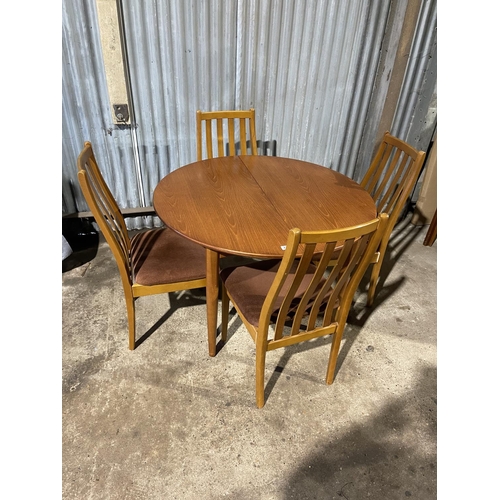 239 - A circular teak dining table together with four matching dining chairs by STATESMAN