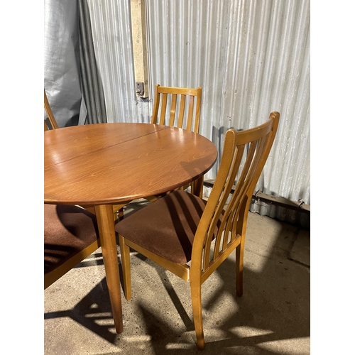 239 - A circular teak dining table together with four matching dining chairs by STATESMAN