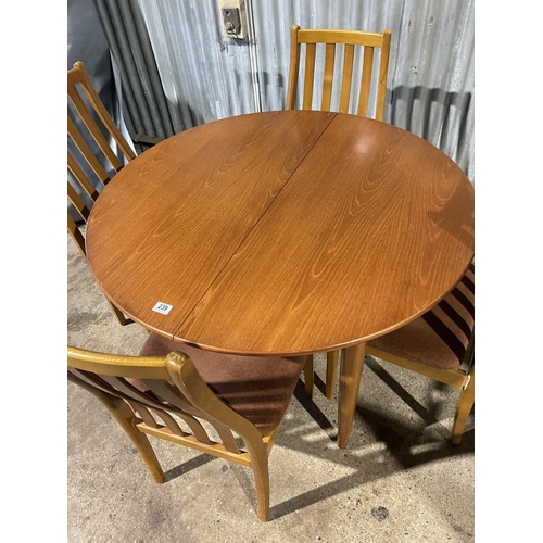 239 - A circular teak dining table together with four matching dining chairs by STATESMAN