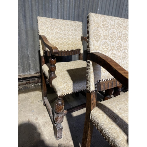 27 - A set of six early 20th century oak dining chairs with beige pattern upholstery