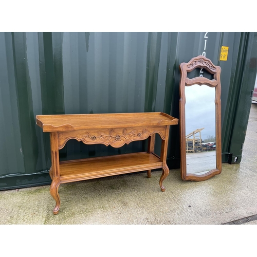 302 - A continental oak console table together with matching mirror