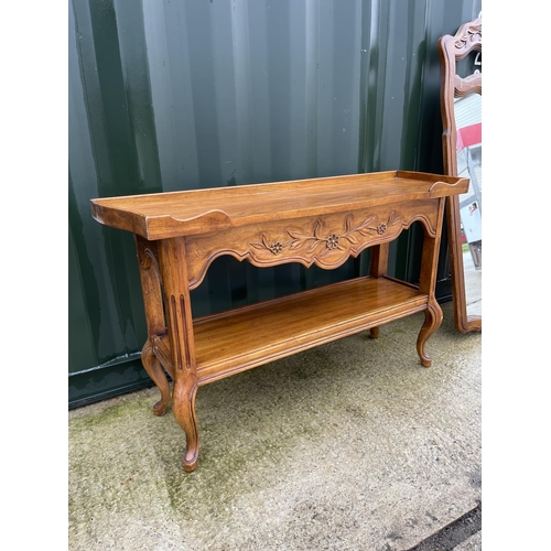 302 - A continental oak console table together with matching mirror