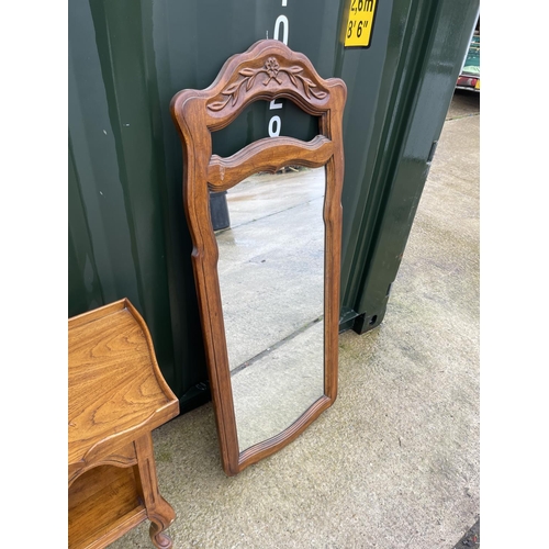 302 - A continental oak console table together with matching mirror