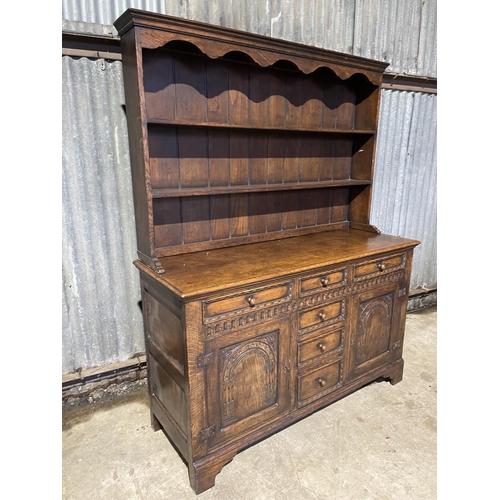 34 - A reproduction oak dresser carved to the front  154x 55x 190