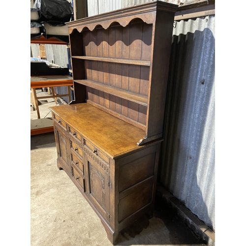 34 - A reproduction oak dresser carved to the front  154x 55x 190