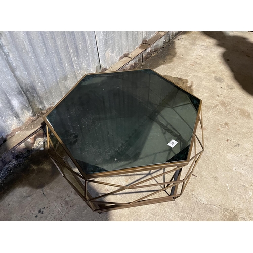 35 - A hexagonal brass coffee table of geometric design with smoked glass drop in top