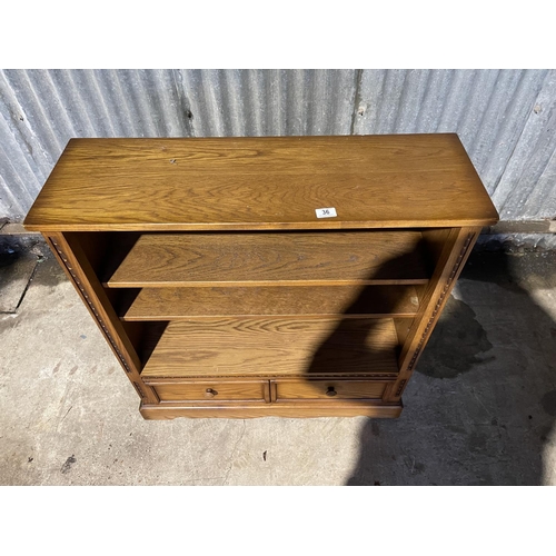 36 - An ercol golden dawn bookcase with two drawers