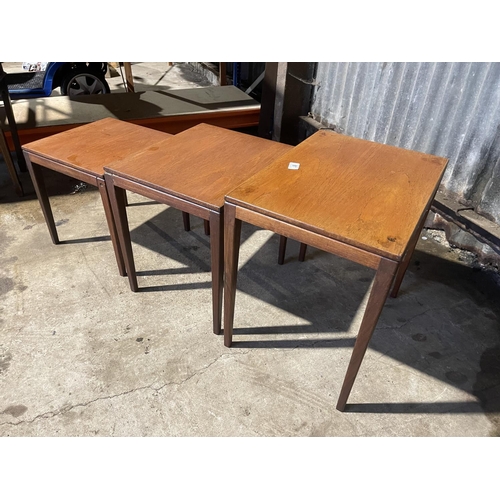 61 - A mid century teak nest of three tables