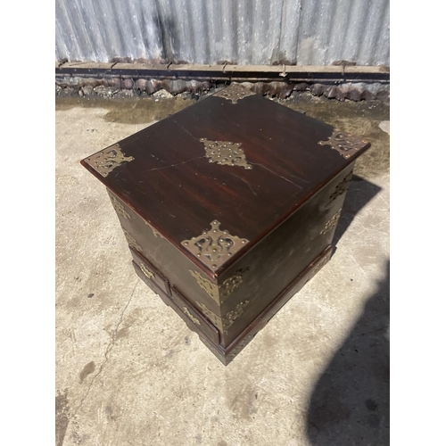 65 - An Indian style hardwood storage box with brass mounts 50x54x50