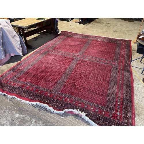 69 - A large red oriental pattern carpet 380x285