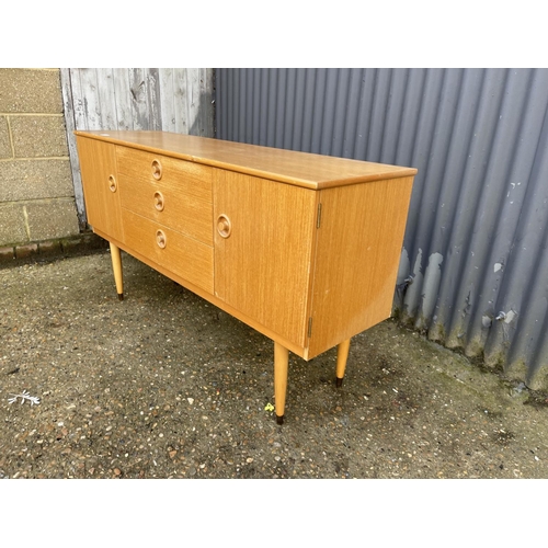 7 - A mid century light oak sideboard