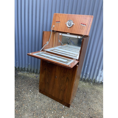 75 - A 1920's walnut cocktail drinks cabinet with juicer and sticks 60x35x110