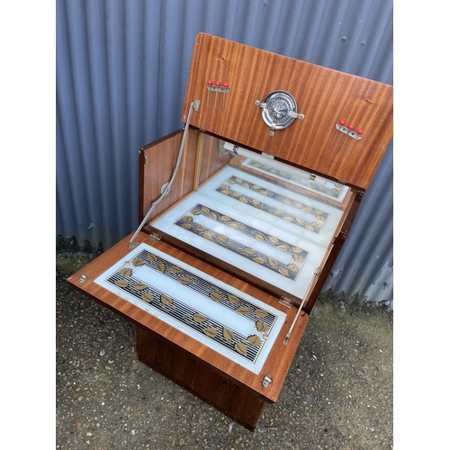 75 - A 1920's walnut cocktail drinks cabinet with juicer and sticks 60x35x110