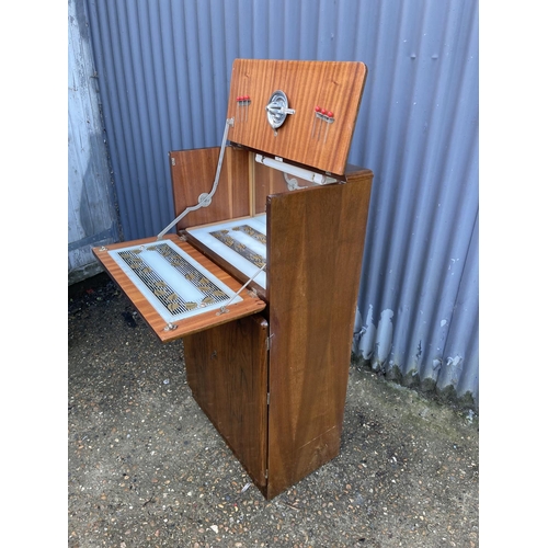 75 - A 1920's walnut cocktail drinks cabinet with juicer and sticks 60x35x110