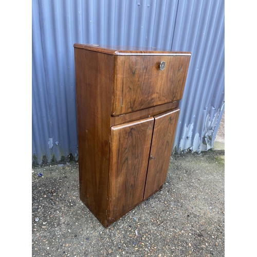 75 - A 1920's walnut cocktail drinks cabinet with juicer and sticks 60x35x110