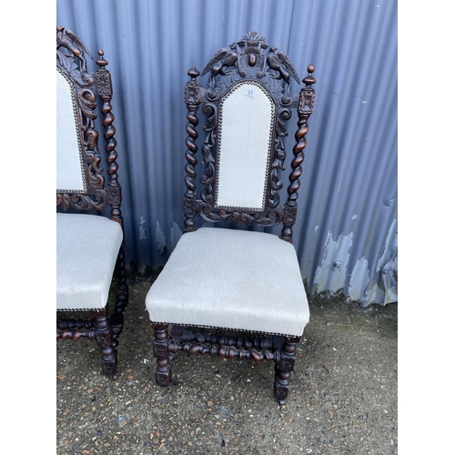 91 - A pair of carved oak chairs, together with a vintage case