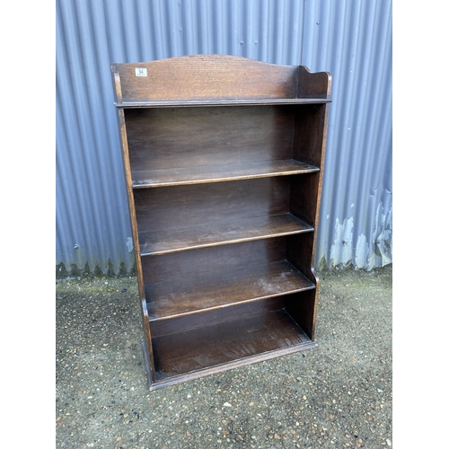 94 - An early 20th open fronted oak bookcase