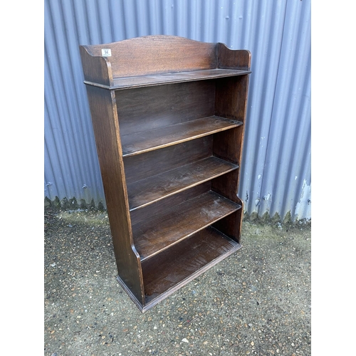 94 - An early 20th open fronted oak bookcase