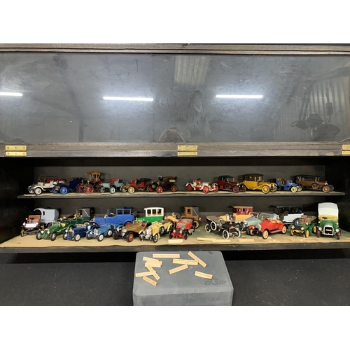 951 - Wooden display glazed cabinet with model kit built cars, size 102 cms x 24 cms x 26 cms high