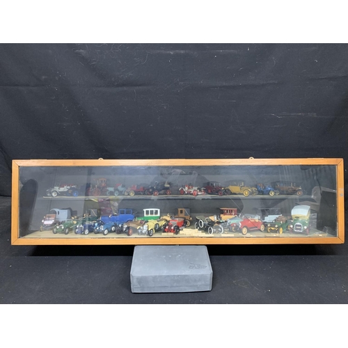 951 - Wooden display glazed cabinet with model kit built cars, size 102 cms x 24 cms x 26 cms high