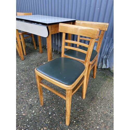 96 - A mid century drop leaf kitchen table and four chairs