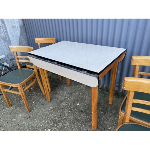 96 - A mid century drop leaf kitchen table and four chairs