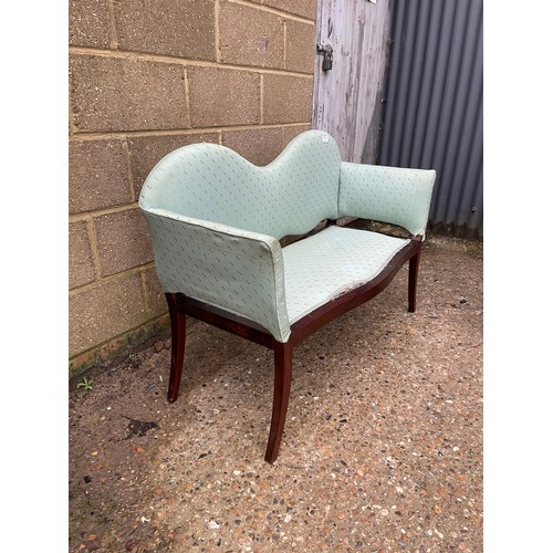 171 - An Edwardian mahogany love seat upholstered in green 112cm wide