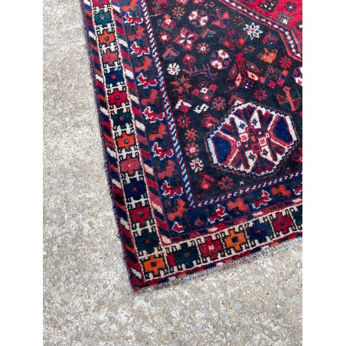 317 - A large red and blue oriental pattern carpet 205x275