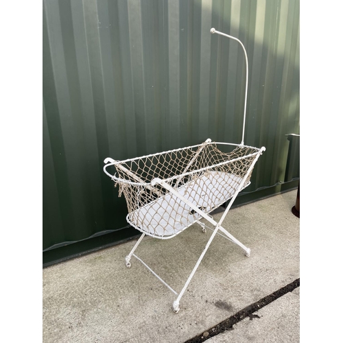 318 - A vintage white painted metal framed folding crib