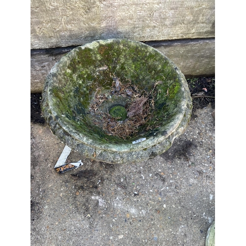 306 - A weathered concrete urn 38 cm diameter