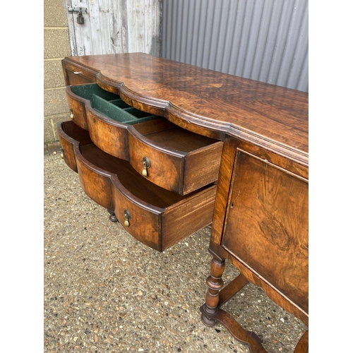 151 - An early 20th century walnut two drawer serving table / sideboard 168x58x90