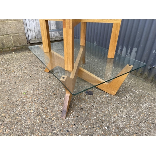 156 - A modern light oak coffee table with glass top together with similar oak and glass lamps table