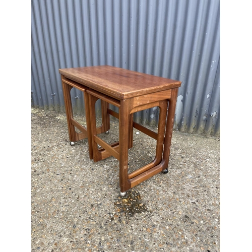 161 - A mcintosh teak of three tables with fold over top