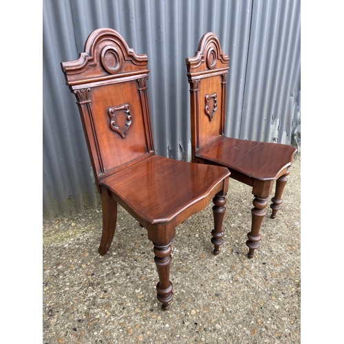 163 - A pair of victorian mahogany hall chairs