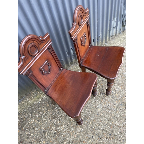 163 - A pair of victorian mahogany hall chairs