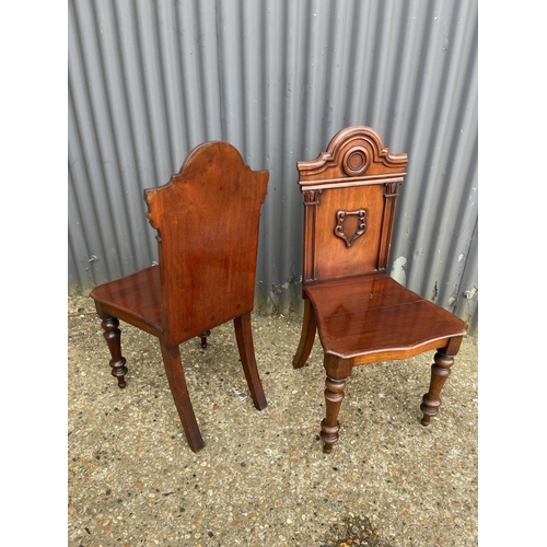 163 - A pair of victorian mahogany hall chairs