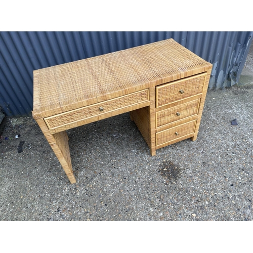 167 - A ratan four drawer desk 117x56x77