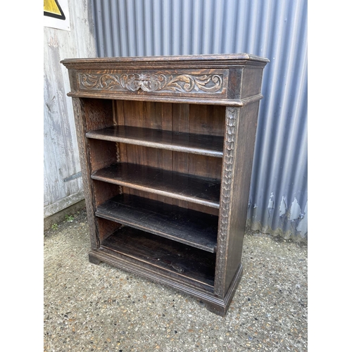 18 - A carved oak open fronted bookcase 94x36x120