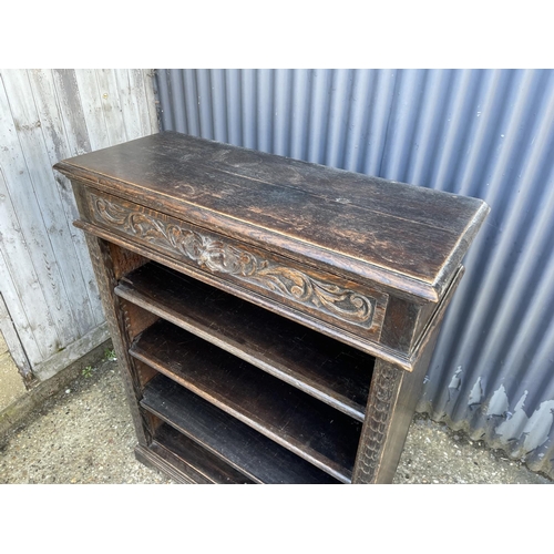 18 - A carved oak open fronted bookcase 94x36x120