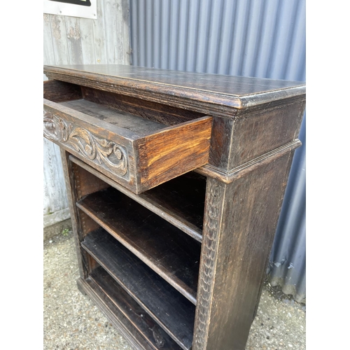 18 - A carved oak open fronted bookcase 94x36x120