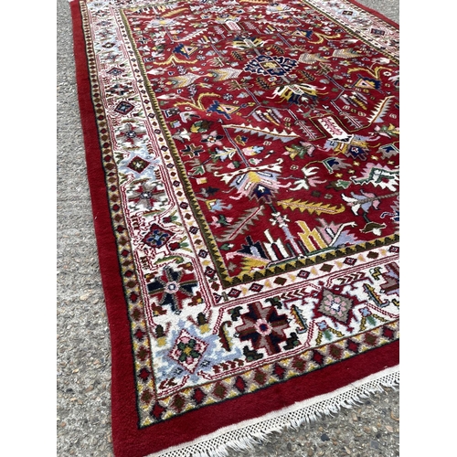 205 - A large red oriental pattern rug 195x300