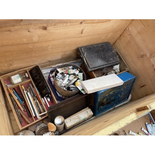 208 - A large pine trunk containing a collection of artists materials, together with a wooden easel, woode... 