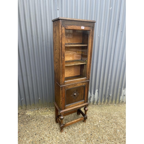 220 - A slim glazed oak bookcase 48x45x150