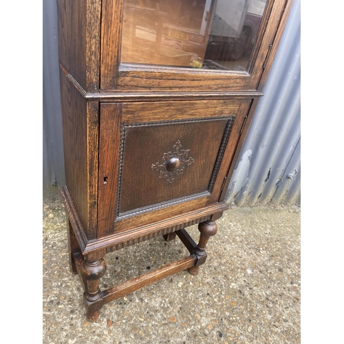 220 - A slim glazed oak bookcase 48x45x150