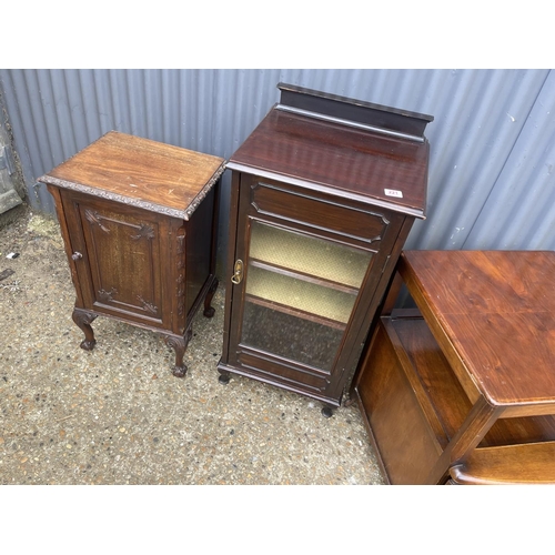 221 - A mahogany music cabinet, a mahogany bedside and a trolley / record cabinet