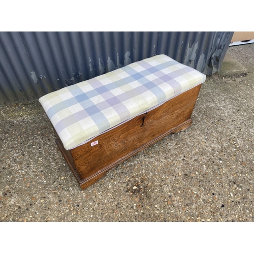 228 - An elm blanket box trunk with upholstered top 97x40x48